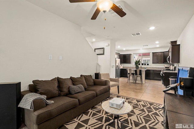 living area with light tile patterned floors, recessed lighting, visible vents, and ceiling fan