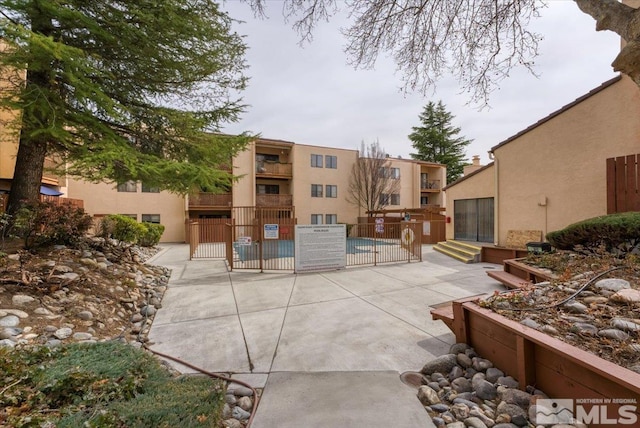 view of community featuring a patio and fence