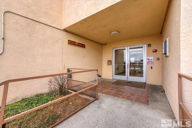 property entrance with stucco siding