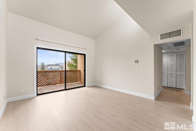 unfurnished room featuring high vaulted ceiling, baseboards, visible vents, and light wood-type flooring