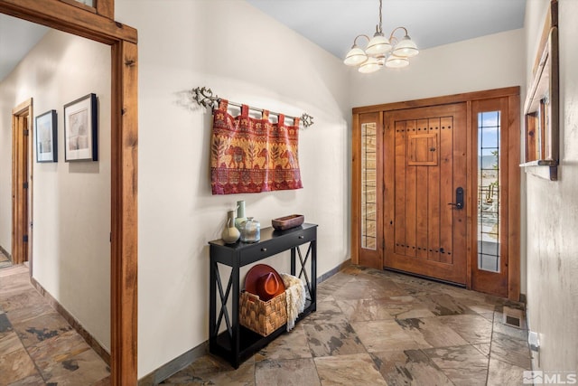 foyer featuring a notable chandelier, visible vents, and baseboards