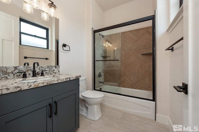 full bath featuring bath / shower combo with glass door, toilet, vanity, and tile patterned flooring