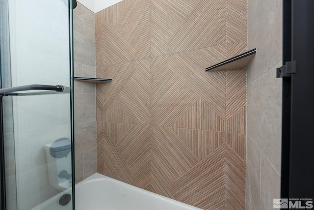 bathroom featuring shower / bath combination with glass door