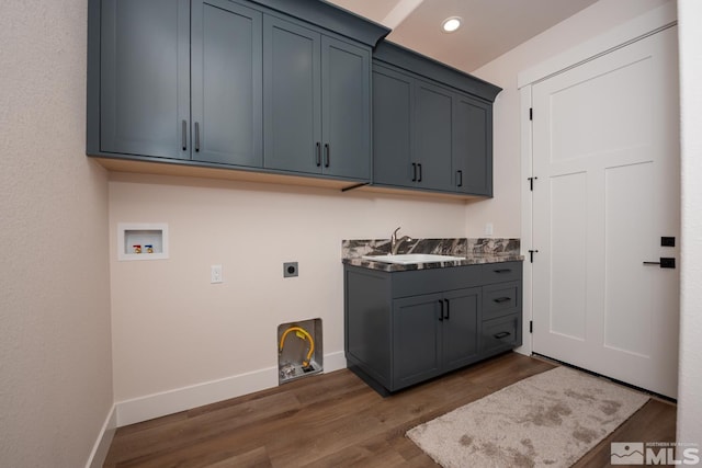 clothes washing area featuring a sink, cabinet space, hookup for an electric dryer, hookup for a washing machine, and dark wood-style flooring