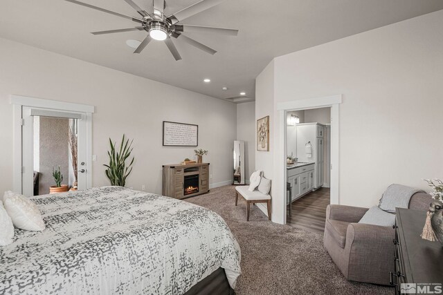 bedroom featuring baseboards, ceiling fan, a lit fireplace, carpet flooring, and recessed lighting