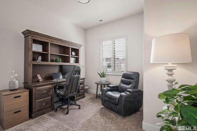 office area with light colored carpet, visible vents, and baseboards