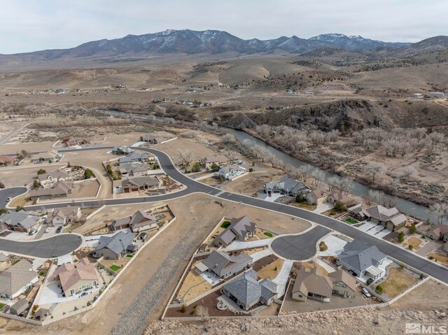 birds eye view of property featuring a residential view and a water and mountain view