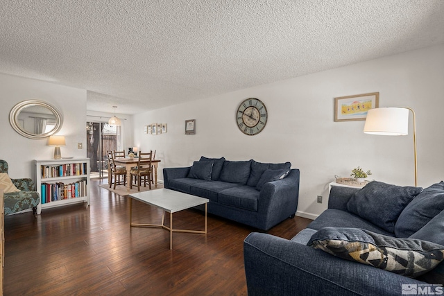 living room with wood finished floors, baseboards, and a textured ceiling