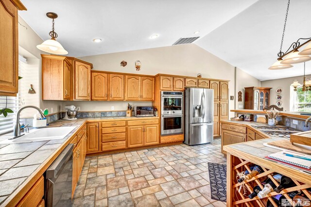 kitchen with decorative light fixtures, visible vents, appliances with stainless steel finishes, and a sink