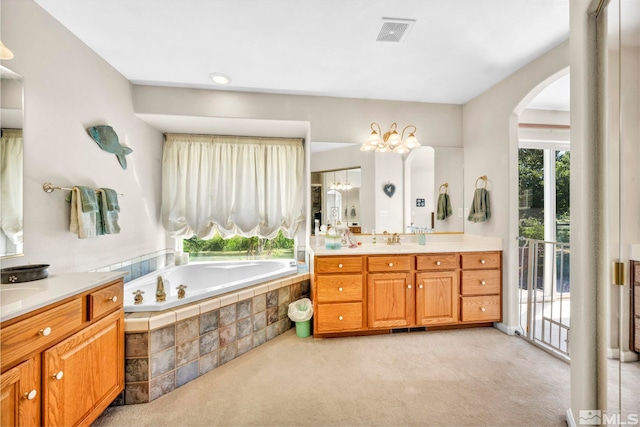 bathroom with vanity, a bath, and visible vents