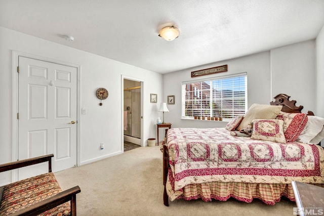 bedroom with baseboards, carpet floors, and connected bathroom