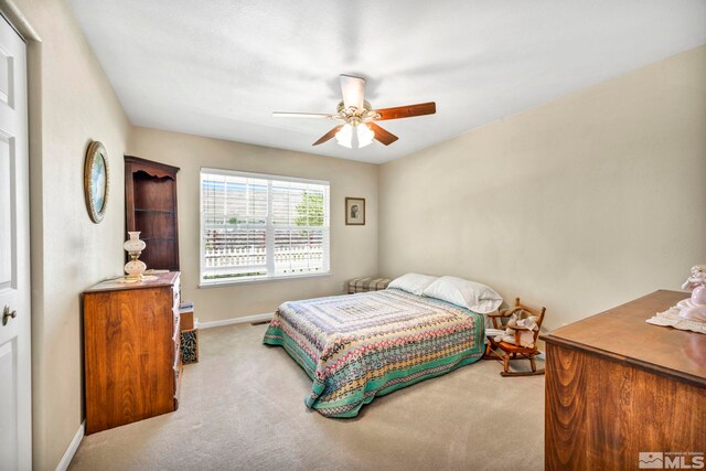 carpeted bedroom featuring a ceiling fan and baseboards