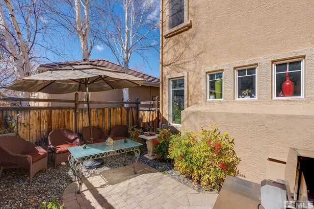 view of patio / terrace featuring fence