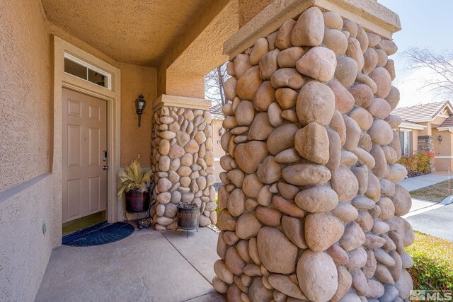 entrance to property featuring stucco siding