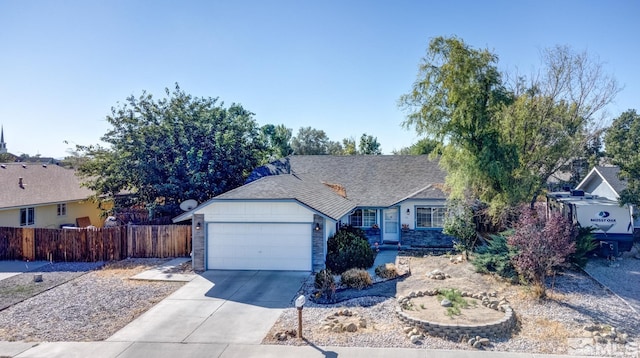 ranch-style house with a garage, driveway, and fence