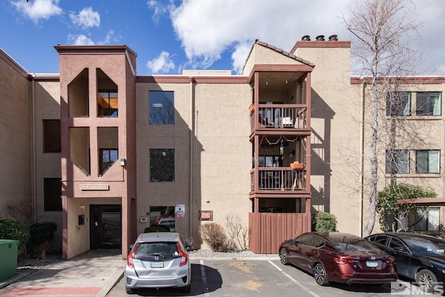 view of building exterior featuring uncovered parking