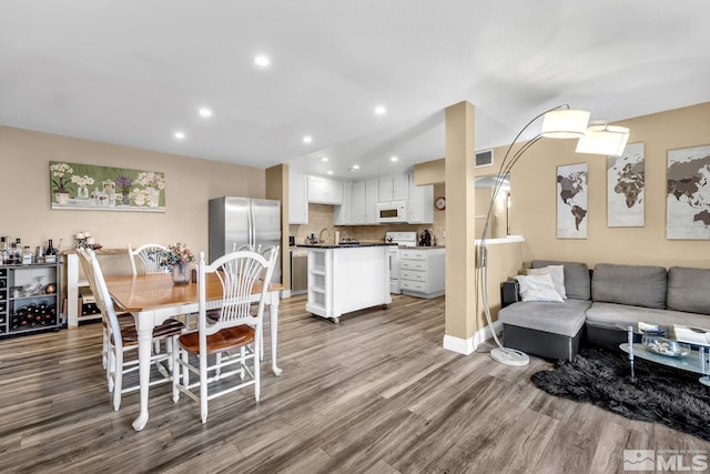 dining room featuring recessed lighting, visible vents, and wood finished floors