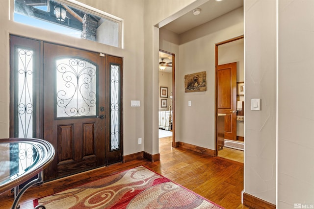 foyer with baseboards and wood finished floors