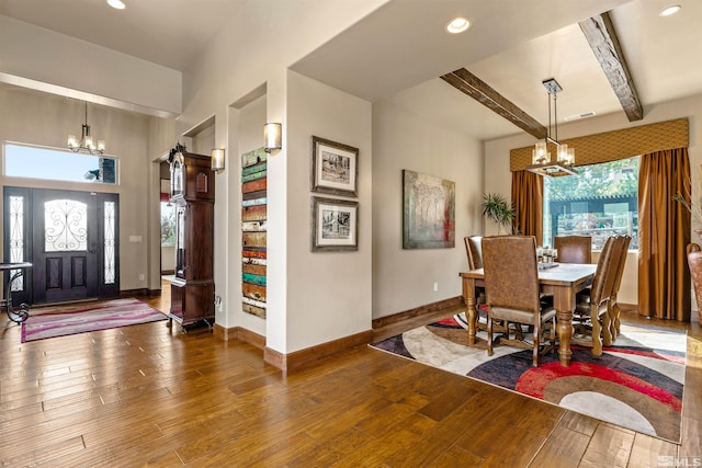 dining room with baseboards, wood-type flooring, beam ceiling, and a chandelier