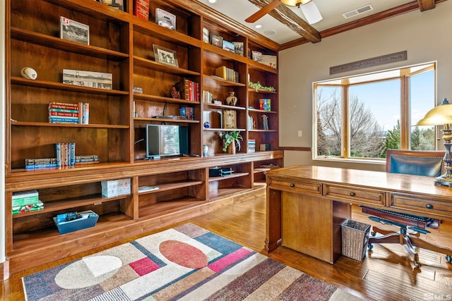 office space with visible vents, ornamental molding, a ceiling fan, and hardwood / wood-style flooring