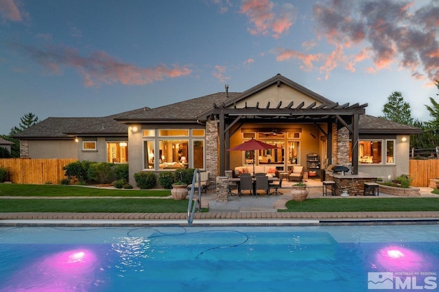 back of property at dusk featuring a fenced in pool, an outdoor living space, fence, stucco siding, and a patio