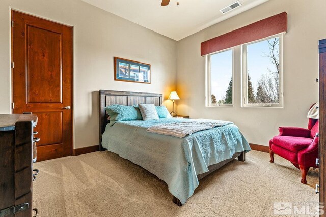 bedroom with ceiling fan, baseboards, visible vents, and light carpet