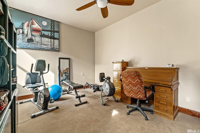 carpeted office with ceiling fan and baseboards