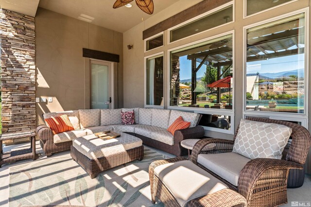 view of patio with outdoor lounge area and ceiling fan