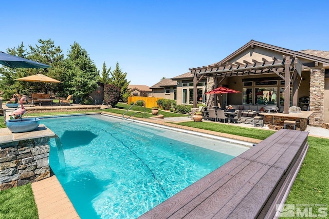 view of pool featuring fence, a patio area, and a lawn