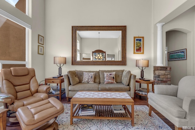 living room with decorative columns and wood finished floors