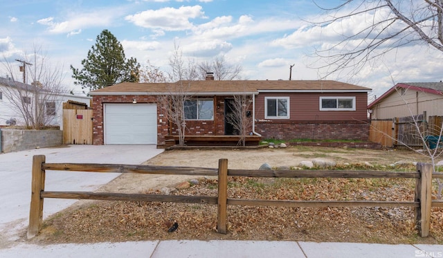 ranch-style home featuring brick siding, a fenced front yard, concrete driveway, a chimney, and a garage