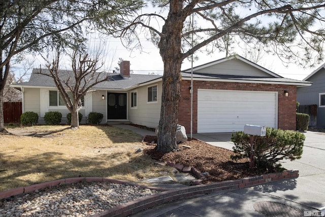 ranch-style home with a garage, brick siding, a chimney, and driveway