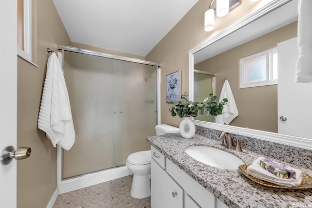 full bathroom with vanity, a shower stall, and toilet