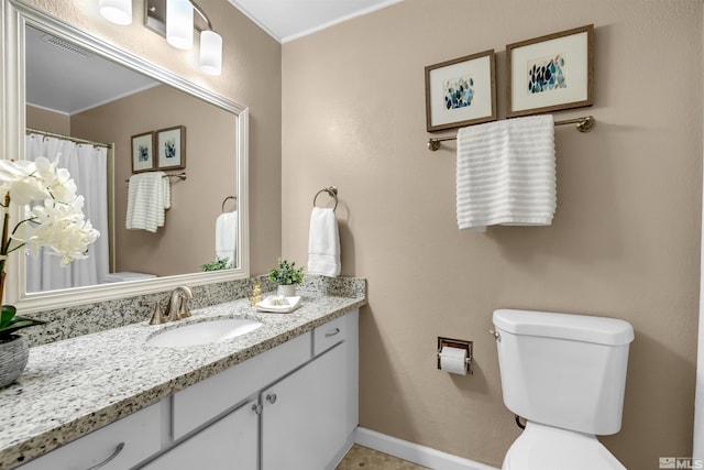 bathroom with visible vents, toilet, vanity, and baseboards