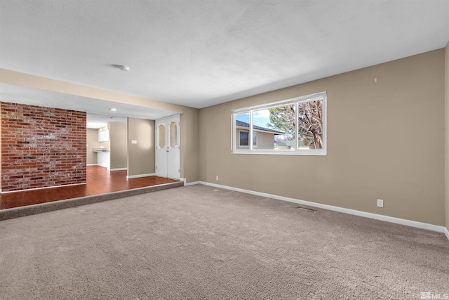 empty room with visible vents, carpet, and baseboards