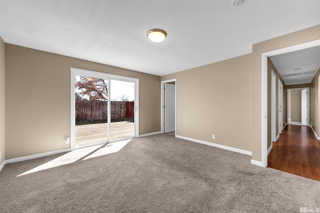 carpeted empty room with baseboards