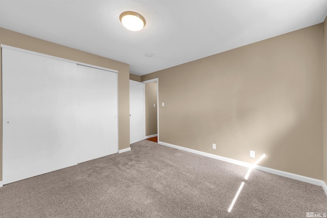 carpeted spare room with baseboards