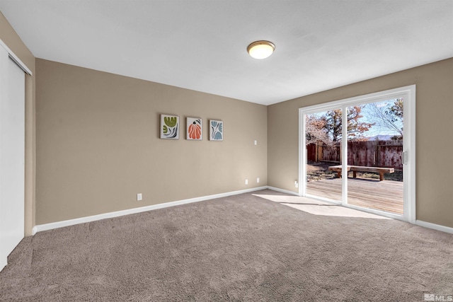 unfurnished bedroom featuring access to outside, carpet flooring, baseboards, and a closet