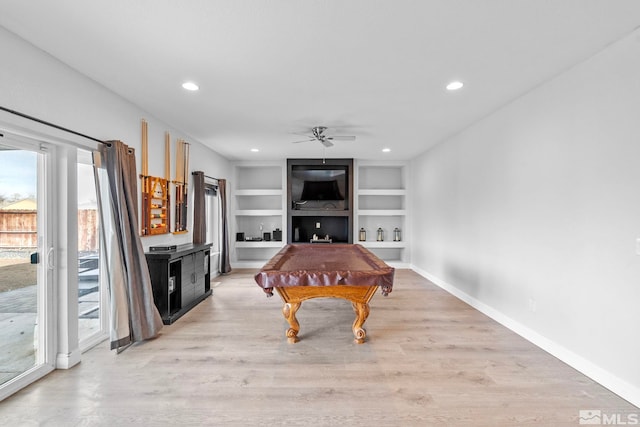 playroom featuring pool table, baseboards, ceiling fan, built in features, and light wood-type flooring