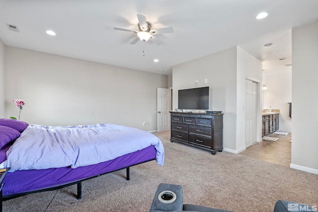 bedroom with baseboards, ceiling fan, light colored carpet, recessed lighting, and ensuite bath