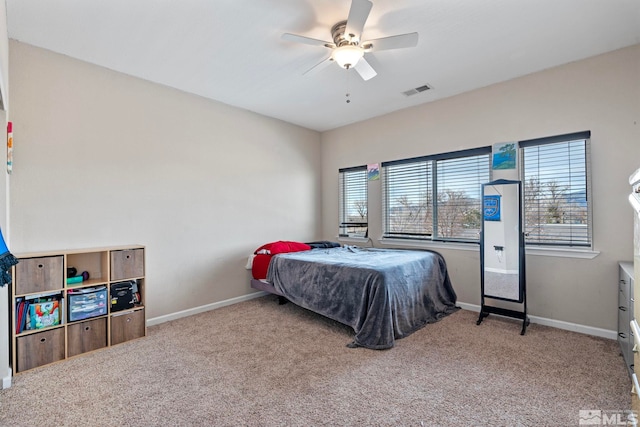 bedroom featuring carpet flooring, visible vents, baseboards, and ceiling fan