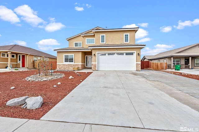 view of front of property with fence, concrete driveway, stucco siding, a garage, and stone siding