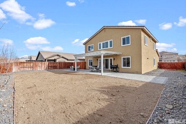 rear view of property featuring a patio, a fenced backyard, a pergola, and stucco siding