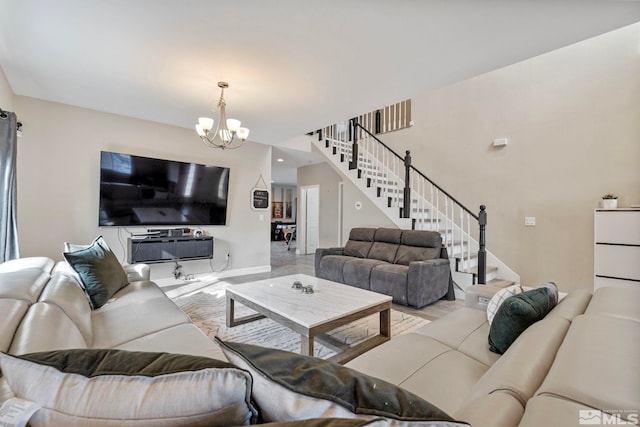 living area featuring stairs, a notable chandelier, and baseboards