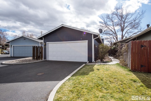 detached garage featuring fence