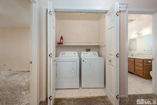 laundry room featuring washer and dryer, light carpet, and laundry area