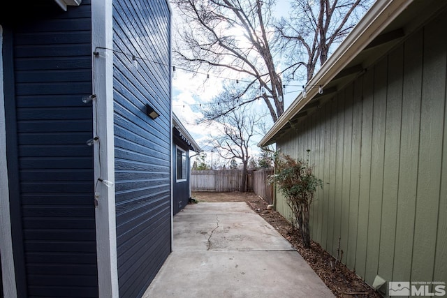 view of side of home featuring a patio area and fence