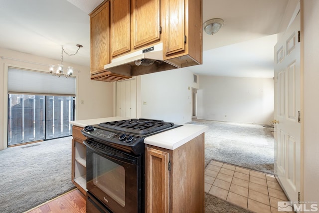 kitchen with black gas stove, a chandelier, under cabinet range hood, and light carpet