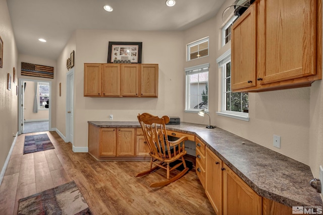 office area with built in desk, recessed lighting, baseboards, and light wood-style floors