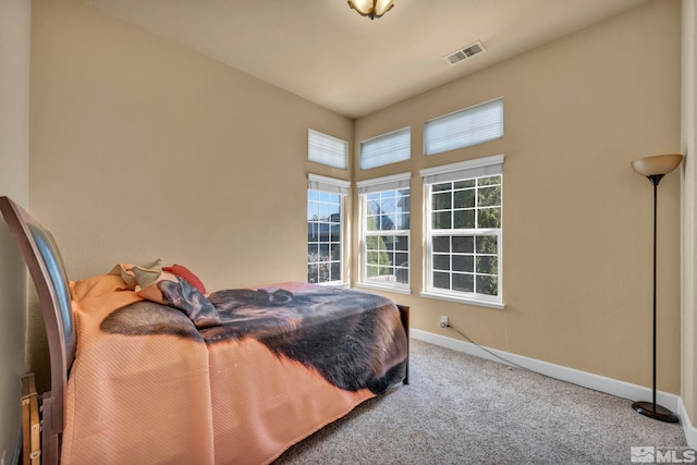 carpeted bedroom with visible vents and baseboards